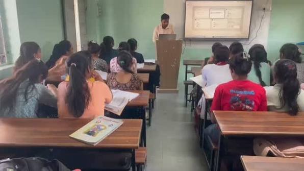 A lecturer teaching a full classroom of BCA students